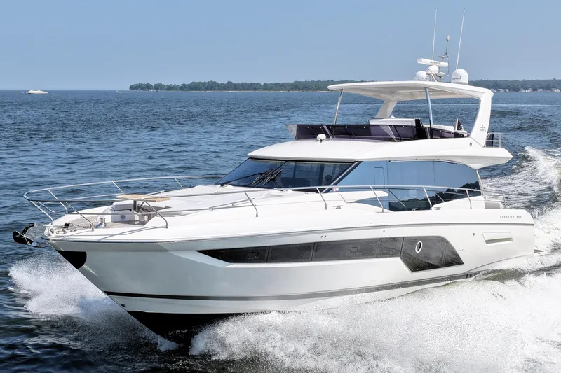 The Image of 2023 Prestige 590 yacht cruising on open water, showcasing sleek design and luxury features. - 0