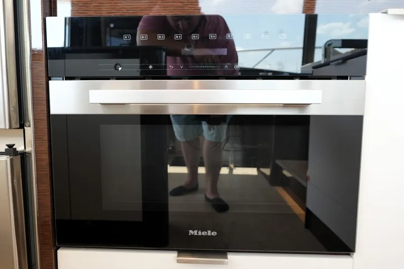 Slide: The Image of Modern Miele oven in a 2023 Prestige 590 yacht kitchen. - 52