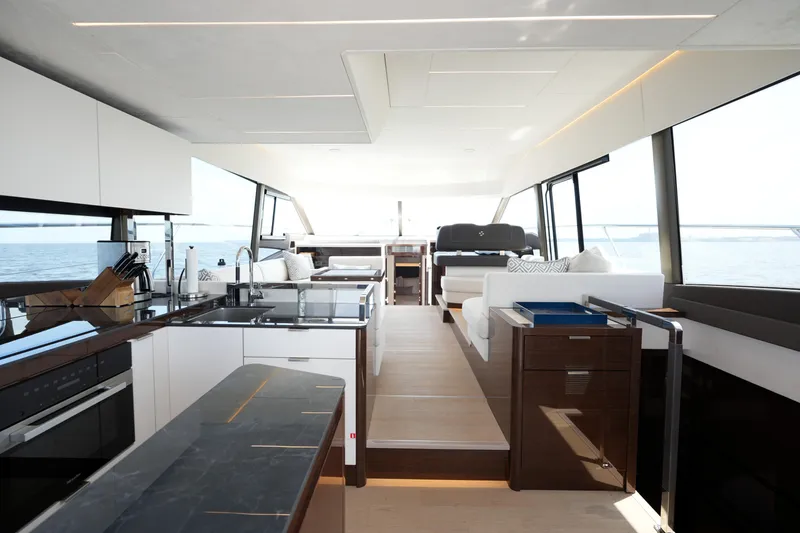 Slide: The Image of Luxurious interior of 2023 Prestige 590 yacht with modern kitchen and seating area. - 43