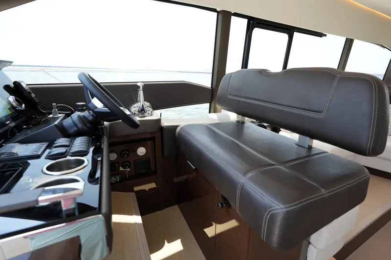 Slide: The Image of Luxurious interior of 2023 Prestige 590 yacht with modern helm and leather seating. - 61