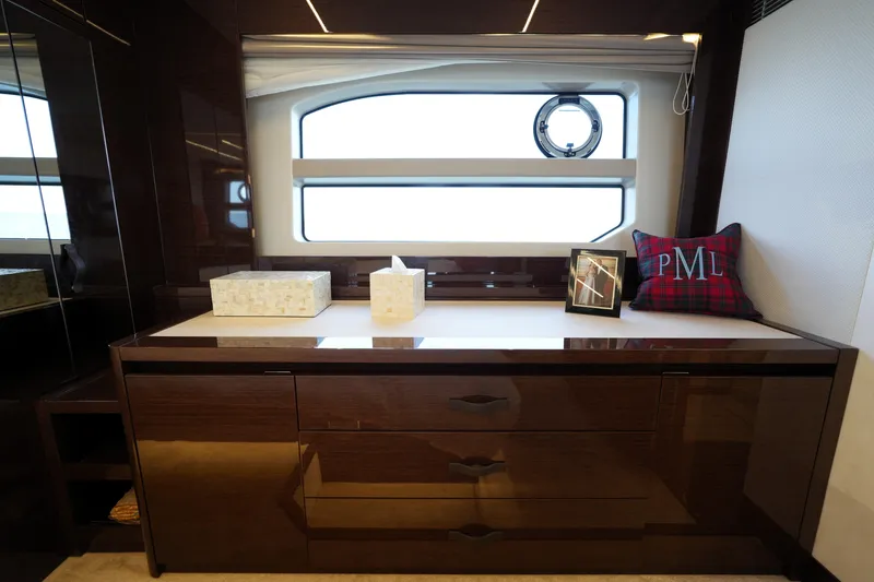 Slide: The Image of Luxurious interior of 2023 Prestige 590 yacht with elegant wooden cabinetry and decorative accents. - 81