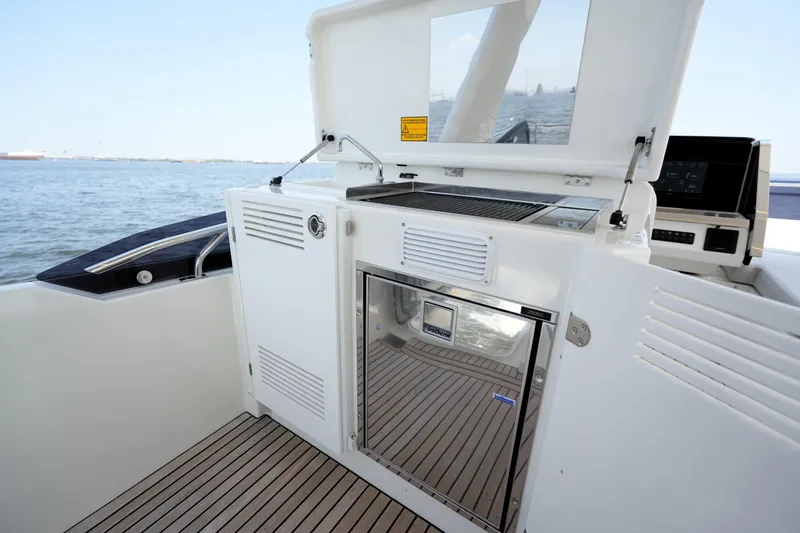 Slide: The Image of Prestige 590 yacht outdoor kitchen with grill and refrigerator, 2023 model. - 42