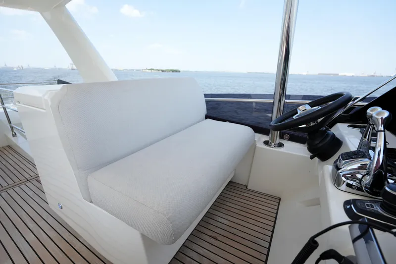 Slide: The Image of Luxurious 2023 Prestige 590 yacht helm with plush seating and sleek controls. - 37