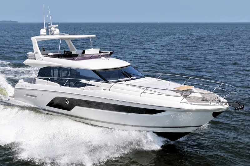 Slide: The Image of Luxurious 2023 Prestige 590 yacht cruising on open water, showcasing sleek design and elegance. - 10