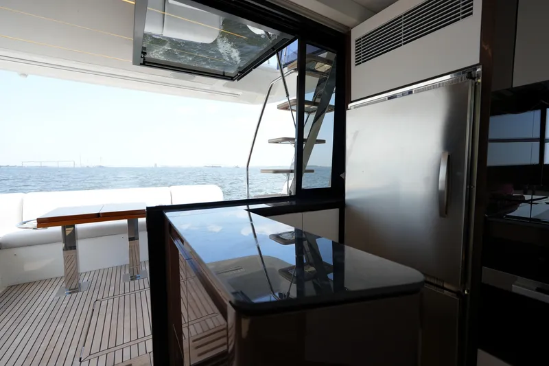 Slide: The Image of Luxurious interior of 2023 Prestige 590 yacht with ocean view and modern kitchen amenities. - 49