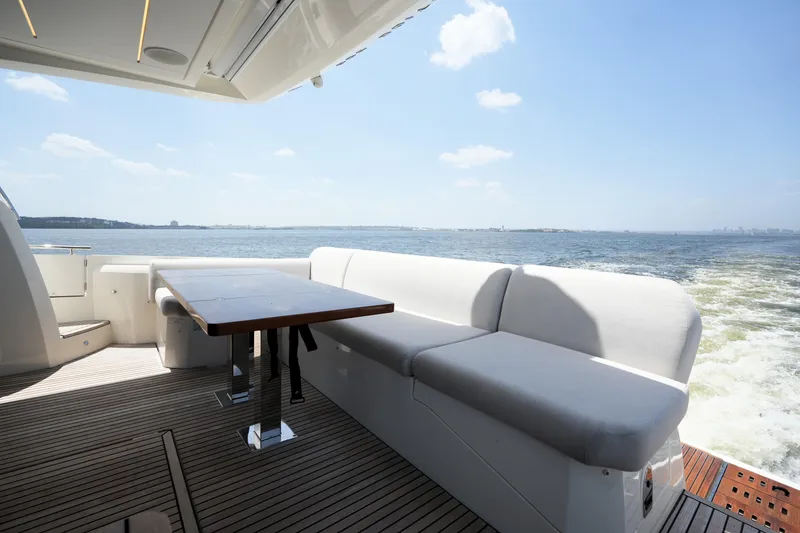 Slide: The Image of Luxurious 2023 Prestige 590 yacht deck with seating and ocean view. - 18