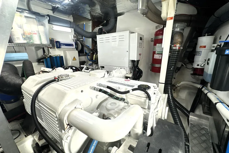 Slide: The Image of Engine room of a 2023 Prestige 590 yacht, showcasing machinery and equipment. - 90