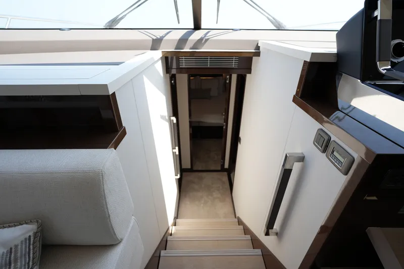 Slide: The Image of Interior view of 2023 Prestige 590 yacht, showcasing modern staircase and sleek design. - 65