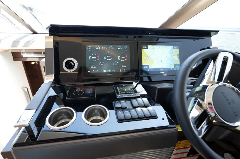 Slide: The Image of Helm of 2023 Prestige 590 yacht with advanced navigation displays and controls. - 64