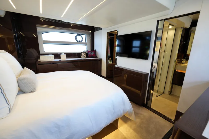 Slide: The Image of Luxurious bedroom interior of 2023 Prestige 590 yacht with modern decor and large window. - 78