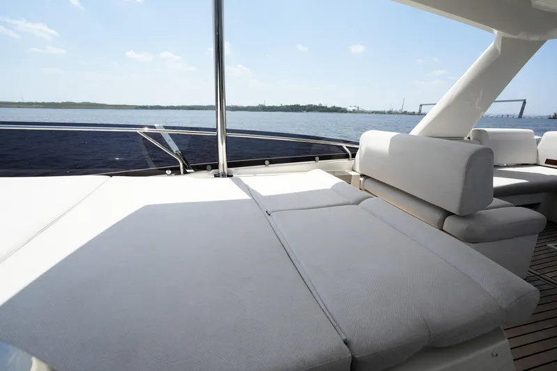 Slide: The Image of Luxurious 2023 Prestige 590 yacht with spacious sunbathing deck, overlooking serene waters. - 36