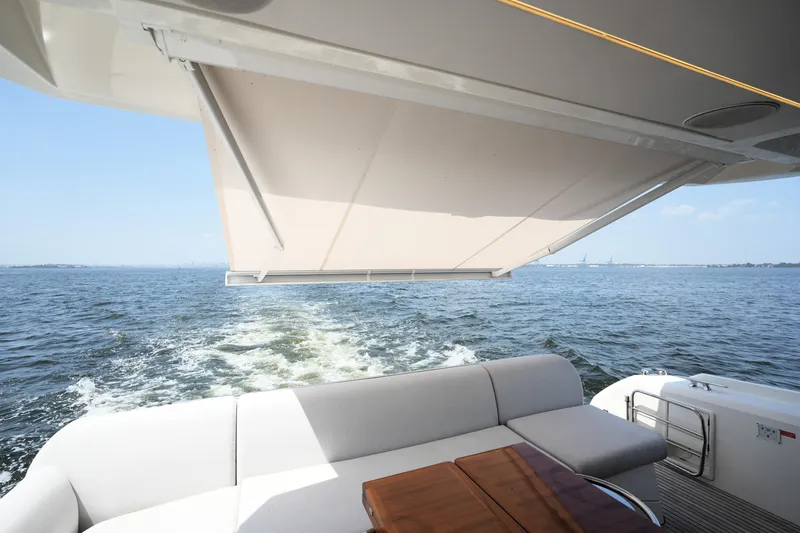 Slide: The Image of Luxury yacht Prestige 590, 2023 model, cruising with elegant seating and retractable awning. - 22