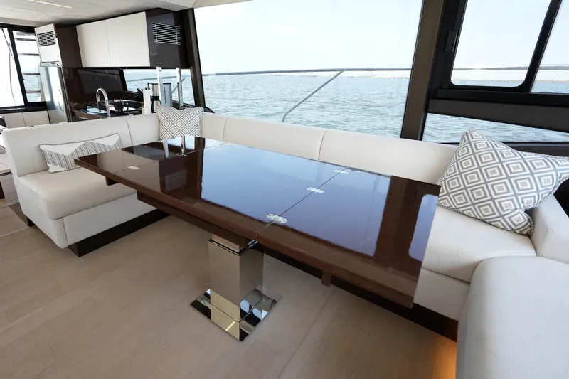 Slide: The Image of Luxurious interior of 2023 Prestige 590 yacht with elegant dining area and ocean view. - 56