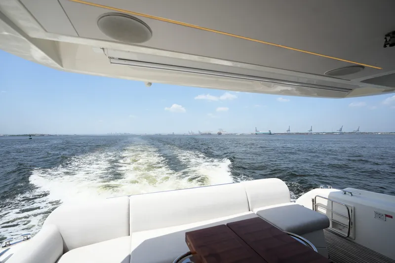 Slide: The Image of Prestige 590 yacht cruising on open water, showcasing luxury and comfort, 2023 model. - 21