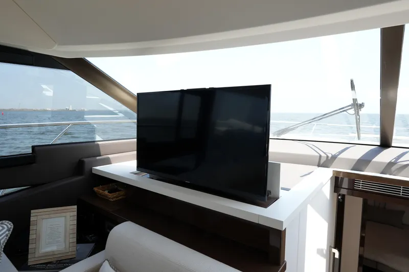 Slide: The Image of Luxurious interior of 2023 Prestige 590 yacht with modern TV and ocean view. - 60