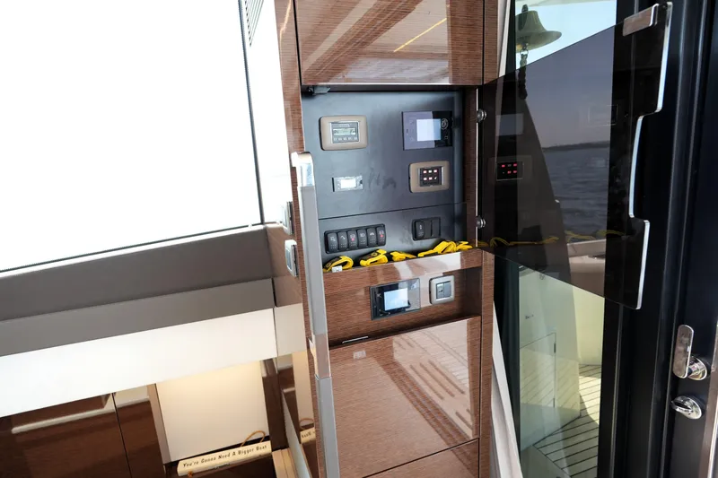 Slide: The Image of Control panel inside 2023 Prestige 590 yacht, featuring modern navigation and electrical systems. - 45