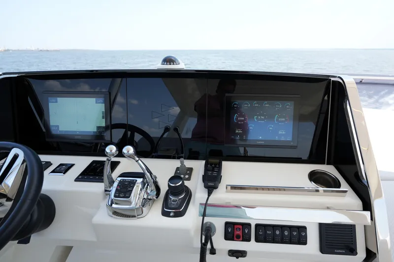 Slide: The Image of Control panel of a 2023 Prestige 590 yacht with navigation screens and controls. - 40