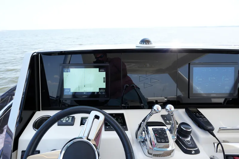 Slide: The Image of Helm of 2023 Prestige 590 yacht with advanced navigation displays and controls. - 39