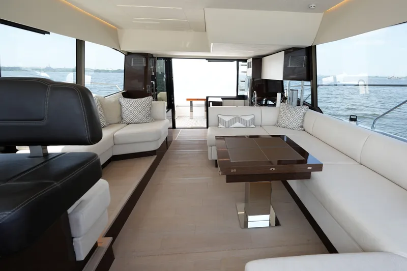 Slide: The Image of Luxurious interior of 2023 Prestige 590 yacht with elegant seating and panoramic windows. - 44