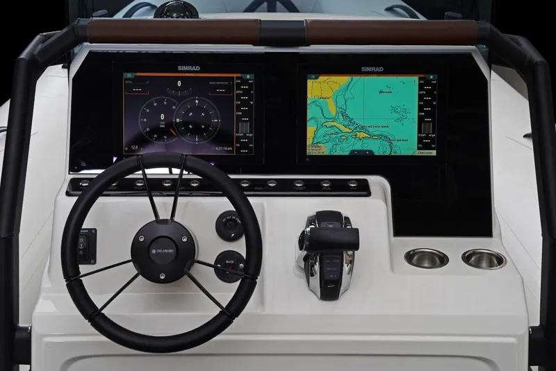 Slide: The Image of Dashboard of 2027 Brig Navigator 24 boat with dual Simrad displays and steering wheel. - 10