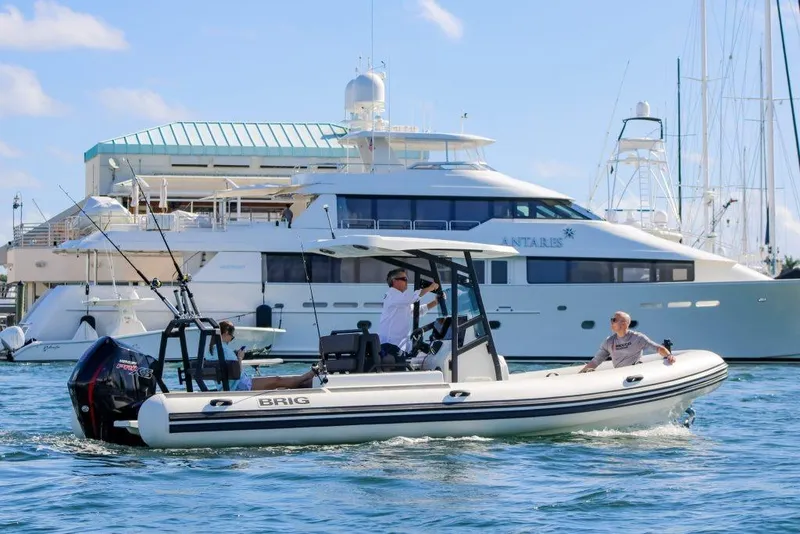 The Image of 2027 Brig Navigator 24 boat cruising in marina with yachts in background. - 0