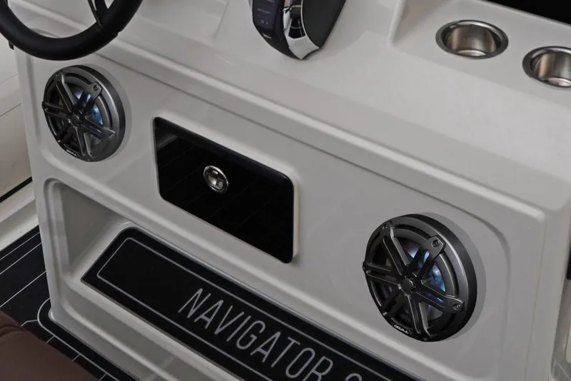 Slide: The Image of 2027 Brig Navigator 24 boat console with speakers and cup holders. - 6