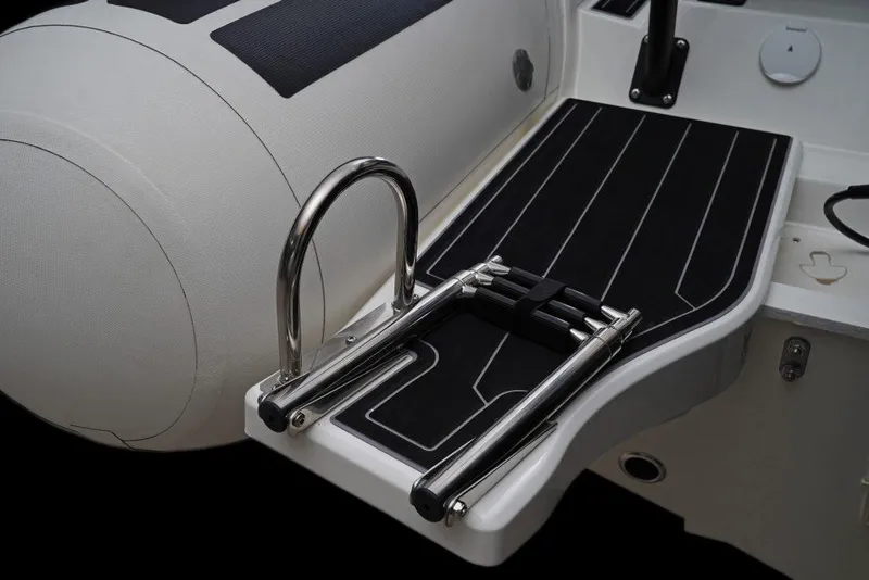 Slide: The Image of 2027 Brig Navigator 24 boat with sleek deck and stainless steel ladder. - 9