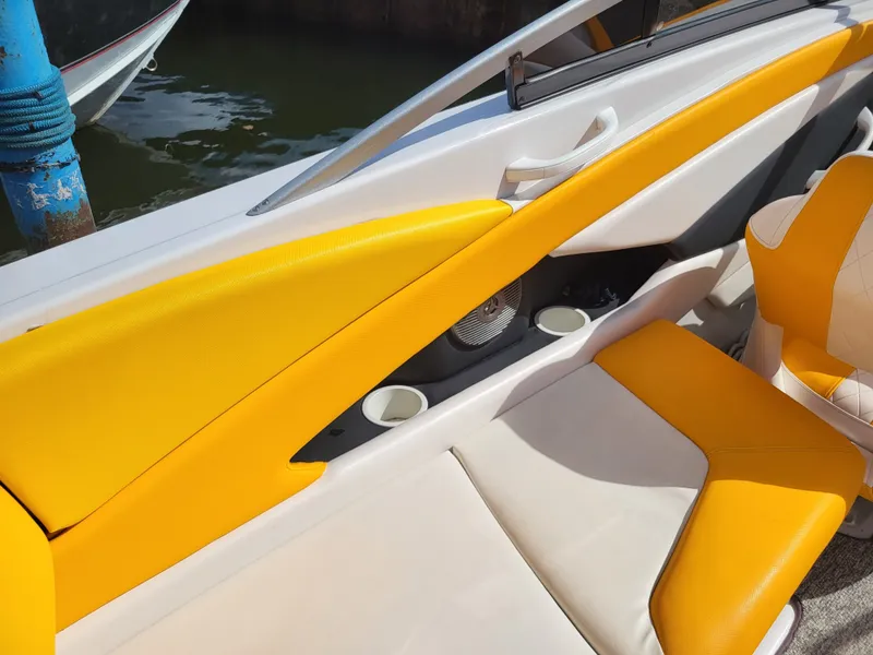 Slide: The Image of The image shows the interior of a Glastron GT 229 boat with yellow and white seating. - 11