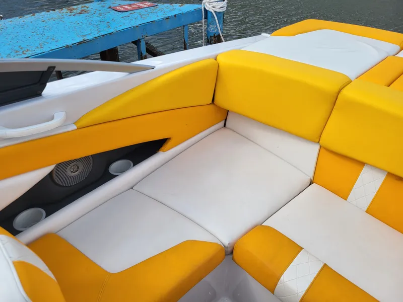 Slide: The Image of The 2014 Glastron GT 229 features yellow and white upholstery in the seating area. - 14