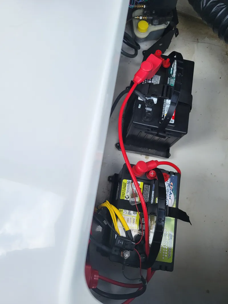 Slide: The Image of Batteries in a boat's engine compartment with red and yellow cables. - 23