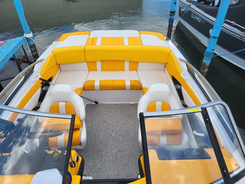 Slide: The Image of The image shows the cockpit of a Glastron GT 229 boat with yellow and white seating. - 4