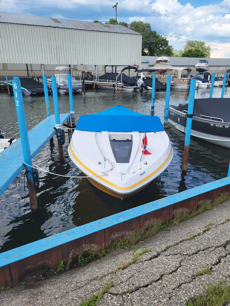 The Image of A 2014 Glastron GT 229 boat docked in the water. - 0