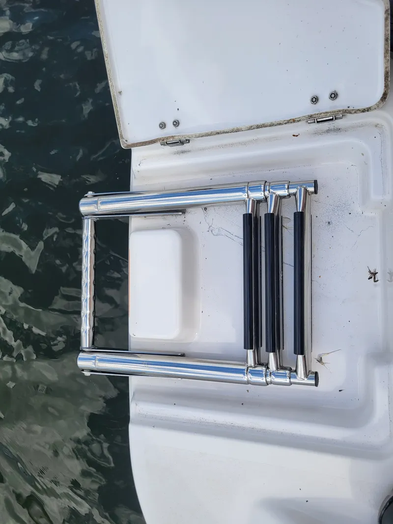 Slide: The Image of A swim ladder on a boat by the water. The ladder is made of metal. - 19