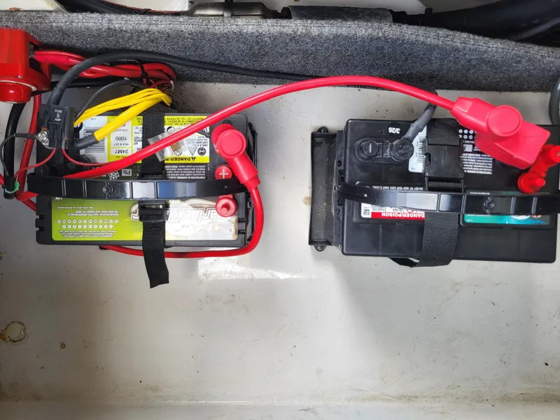 Slide: The Image of Two boat batteries are mounted side by side in a compartment, connected with red and black cables. - 27