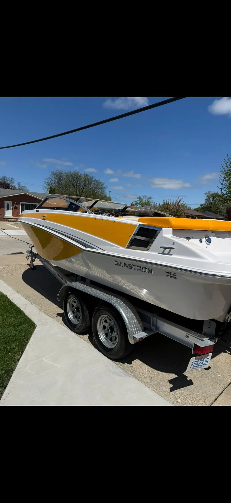 Slide: The Image of A 2014 Glastron GT 229 boat on a trailer, ready for transport. - 2
