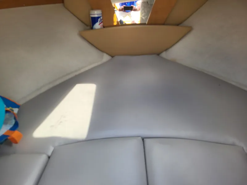 Slide: The Image of Interior of a Glastron GT 229 boat with cushioned seating area and storage space. - 21