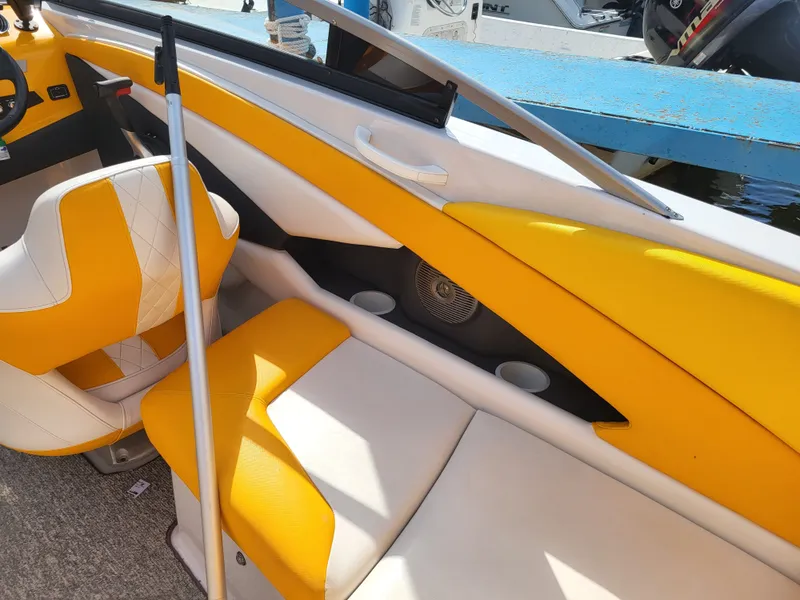Slide: The Image of Interior of a Glastron GT 229 boat with yellow and white seating. - 10