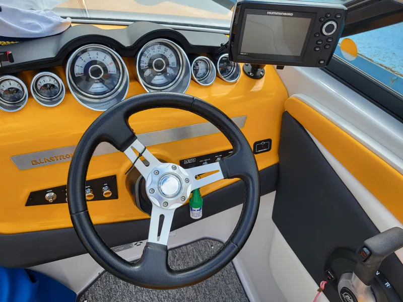 Slide: The Image of The image shows the cockpit of a 2014 Glastron GT 229 with a yellow dashboard. - 6