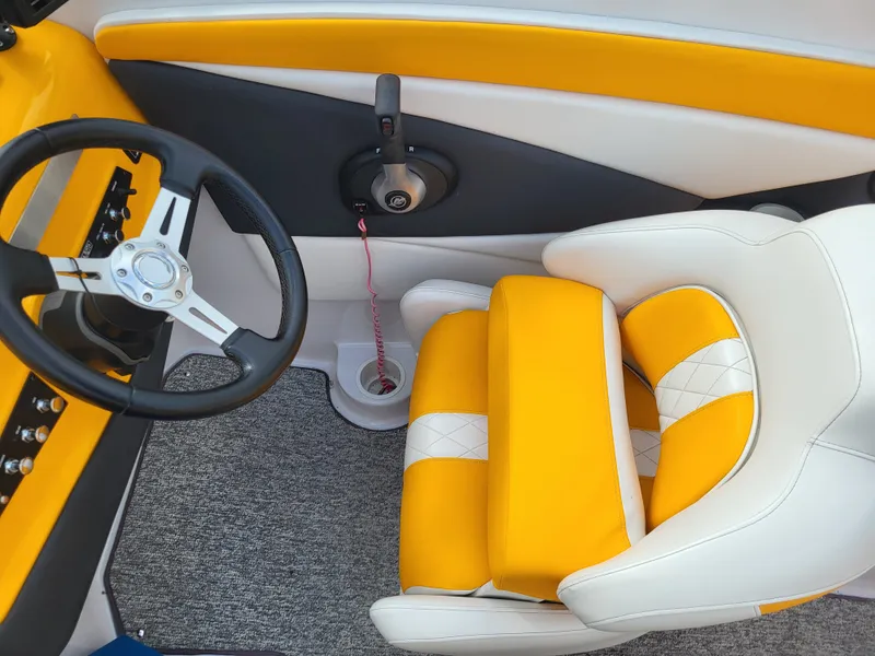 Slide: The Image of The image shows the interior of a Glastron GT 229 boat with yellow and white seating. - 8