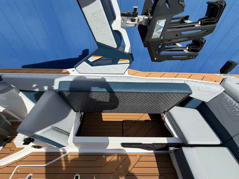 Slide: The Image of The image shows the interior of a 2027 Nautique S25 Super Air with blue and gray upholstery. - 22