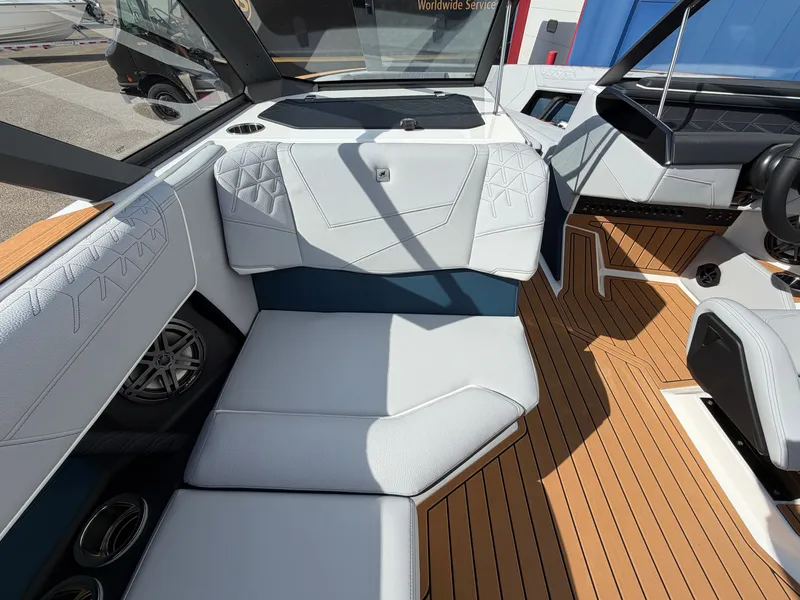 Slide: The Image of The image shows the interior of a 2027 Nautique S25 Super Air with sleek white upholstery. - 28