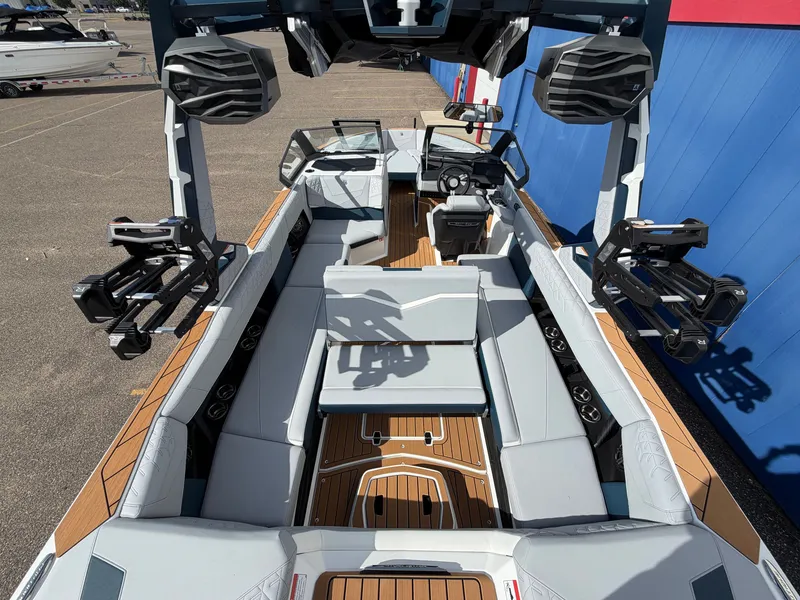 Slide: The Image of The image shows a modern Nautique S25 Super Air boat with stylish interior and wood flooring. - 17