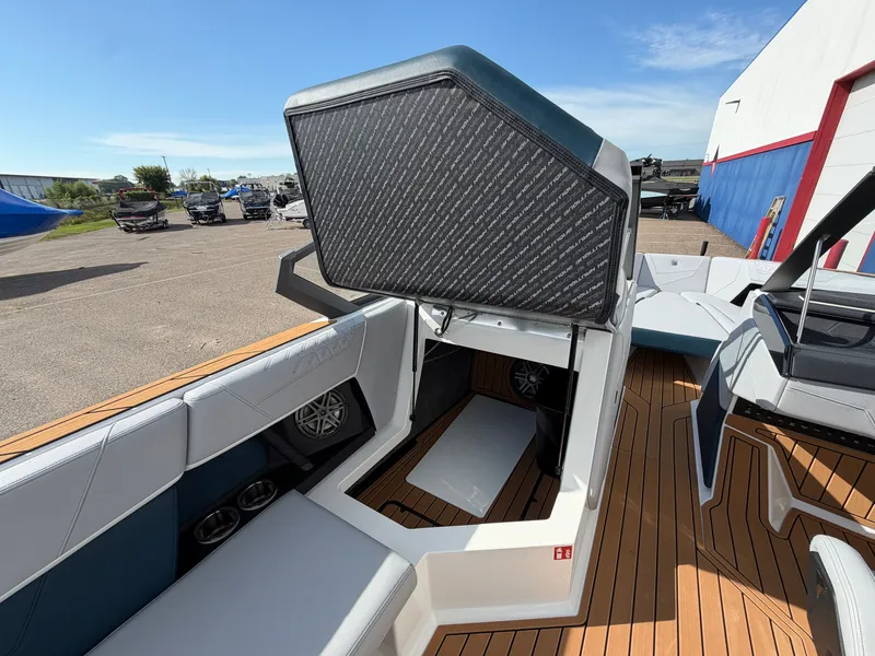 Slide: The Image of The image shows the interior of a 2027 Nautique S25 Super Air with modern seating and storage. - 33