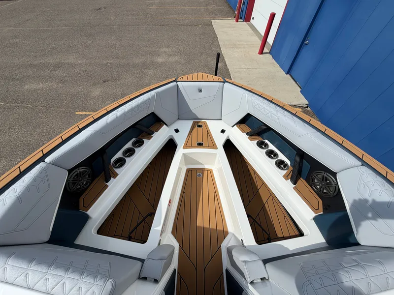 Slide: The Image of The image shows the bow of a 2027 Nautique S25 Super Air with sleek seating and speakers. - 44