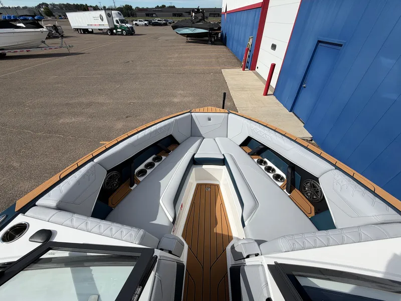 Slide: The Image of The image shows the bow of a 2027 Nautique S25 Super Air with luxurious seating and speakers. - 40