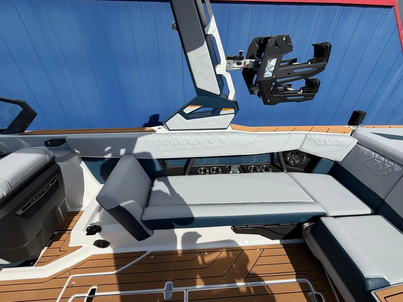 Slide: The Image of The image shows a modern boat cockpit with blue and white upholstery and a wooden floor. - 23