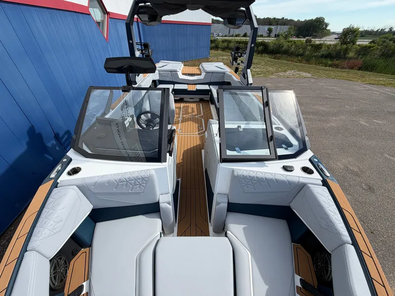 Slide: The Image of The image shows a modern 2027 Nautique S25 Super Air boat with stylish interior. - 48