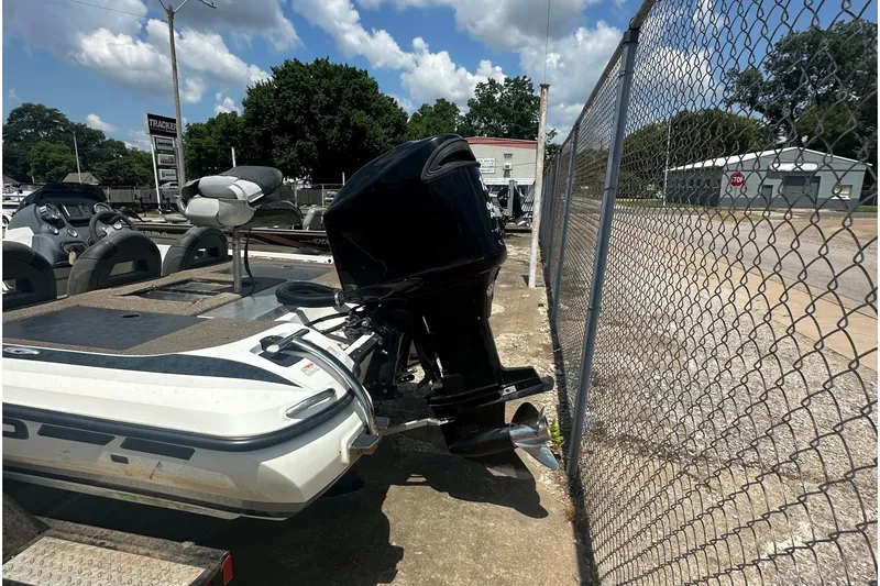 Slide: The Image of A 2012 Nitro Z-7 boat with an outboard motor is parked next to a fence. - 6