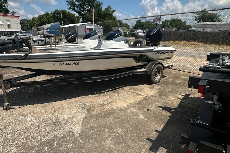 Slide: The Image of A 2012 Nitro Z-7 boat on a trailer in a parking area. - 2