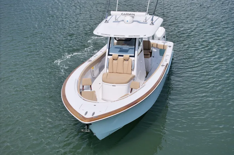 Slide: The Image of 2023 Phenom 34 boat on water, featuring sleek design and modern navigation equipment. - 10